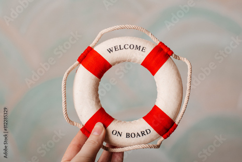 A small lifebuoy with red stripes, a perfect nautical decoration for coastal interiors.