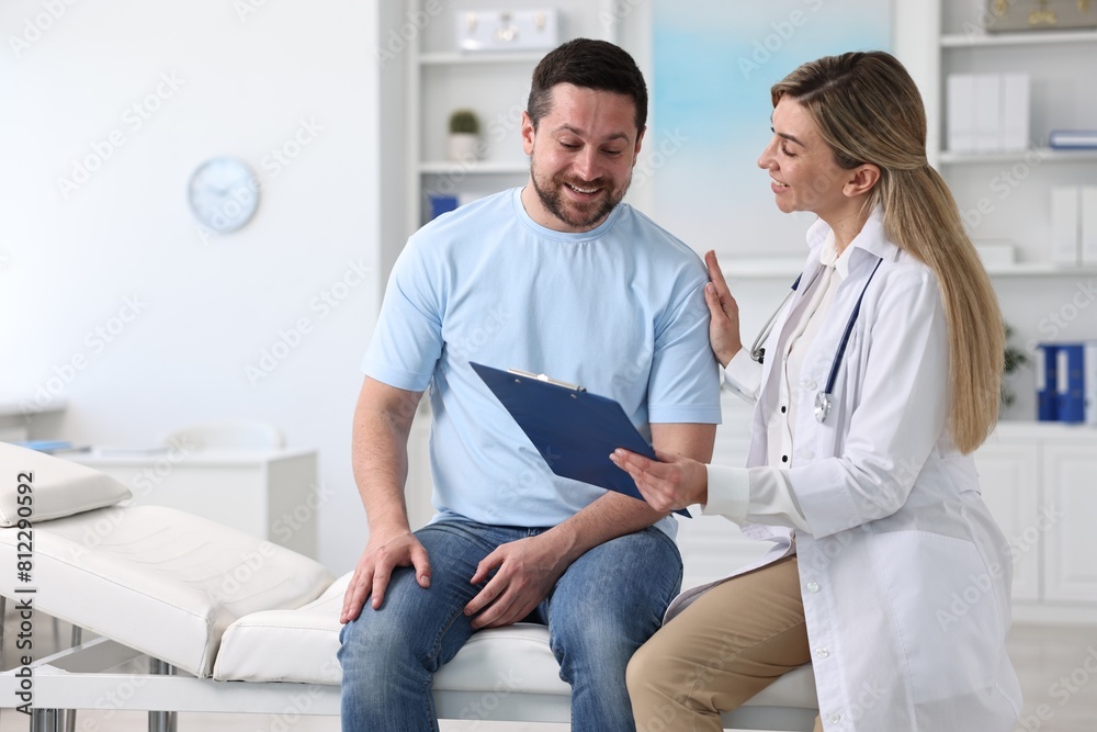 Fototapeta premium Professional doctor working with patient in hospital, space for text