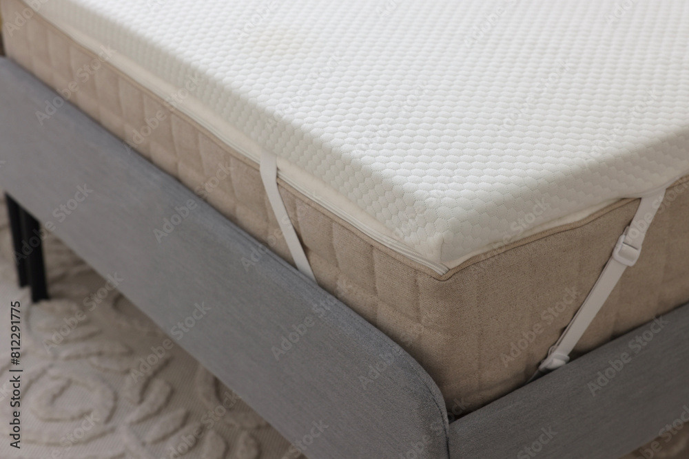 White memory foam mattress topper on grey bed White memory foam mattress topper on grey bed