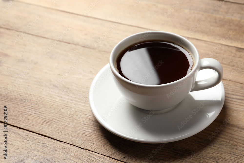 Cup of aromatic coffee on wooden table. Space for text Cup of aromatic coffee on wooden table. Space for text
