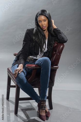 Smiling woman sitting casually on a chair