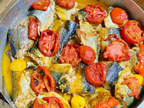 Mackerel fish, baked and cooked with tomatoes, different species of pelagic fish, mostly from the family Scombridae, Mackerel species typically have deeply forked tails and vertical tiger-like stripes © Tamer