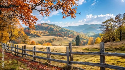 A peaceful countryside landscape with rolling hills and a rustic wooden fence, framed by colorful autumn foliage, a picturesque nature wallpaper.