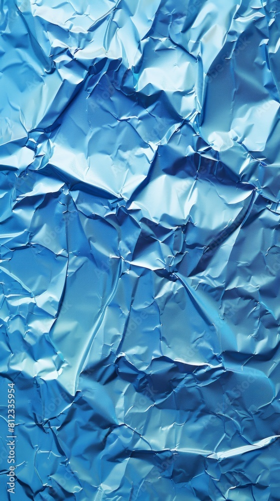 Obraz premium Detailed view of crumpled blue wrapping paper or foil