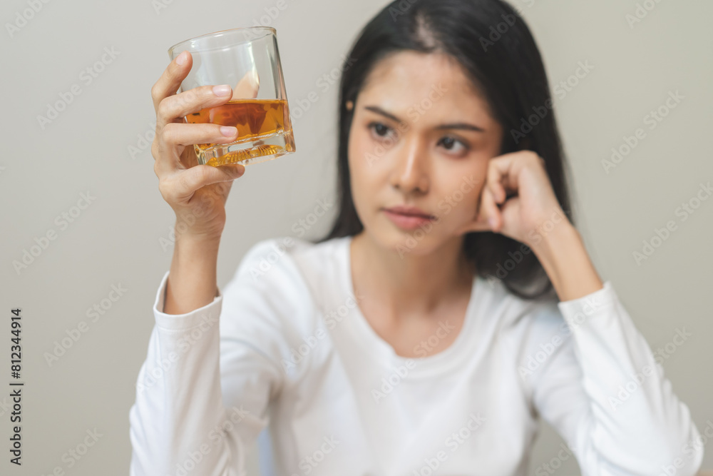 Alcoholism drunk, sad asian young woman fell asleep hand holding glass of alcohol or whiskey, alone depressed alone female drink booze. Treatment of alcohol addiction, suffer abuse problem alcoholism. Alcoholism drunk, sad asian young woman fell asleep hand holding glass of alcohol or whiskey, alone depressed alone female drink booze. Treatment of alcohol addiction, suffer abuse problem alcoholism.
