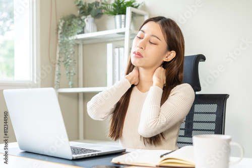 Body muscles stiff problem, ache asian young woman, girl pain neck while sitting work on chair at home, holding massaging rubbing, hurt or sore, Healthcare people, office syndrome.