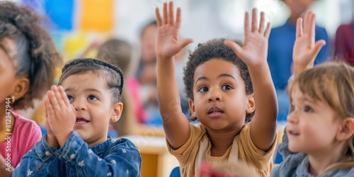 Eager young children raise their hands in a brightly lit classroom, reflecting curiosity, participation, and the joy of learning © gunzexx png and bg