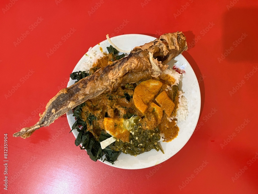 Indonesian Nasi Padang is a complete buffet dish with fried catfish ...