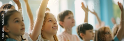 Group of excited children with raised hands in a bright classroom setting