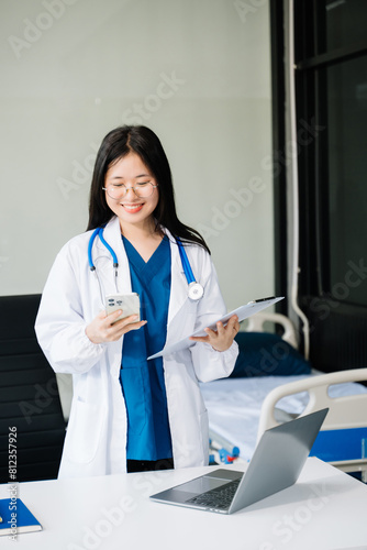 Beautiful physician doctor sit on table in office hospital. Attractive therapist female practitioner pharmacist smile