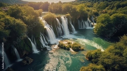 beautiful waterfall with blue water. The waterfall cascades down the rocks  creating a fine mist around it.