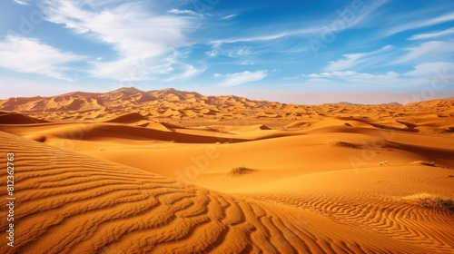 beautiful view of the desert. The bright yellow sand forms wide  smooth hills  with bright blue skies and white clouds adorning them