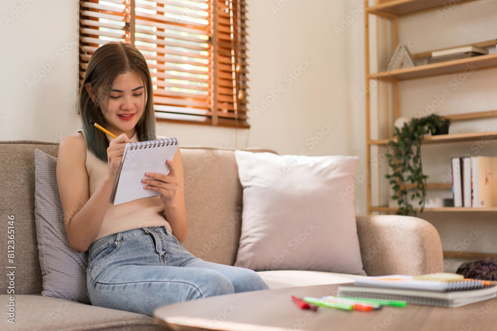Creative design concept, Fashion designer sketching to creating new collection dress on the couch Creative design concept, Fashion designer sketching to creating new collection dress on the couch