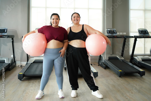 Healthy fat women and friend.  Asian woman fitness exercise for lose weight.  People overweight training and exercising sport in the gym for body healthy.   Healthy Lifestyle Concept