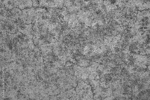 Dirty old cracked concrete floor texture background. Black mould on cement surface. Grunge and rough backdrop. Gray stone wall. 