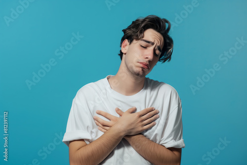 Man holds chest, concerned for psychological and physical health