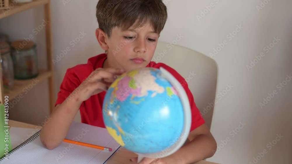 Schoolboy Looking For Countries On The Globe. Elementary Child Doing Homework. Back To School. Schoolboy Looking For Countries On The Globe. Elementary Child Doing Homework. Back To School.