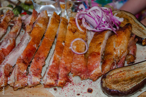 Roast pork in the oven cut into chunks and sprinkled with fresh onions