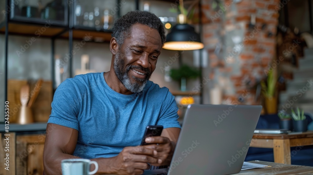 Man Sitting at Table Looking at Cell Phone Man Sitting at Table Looking at Cell Phone