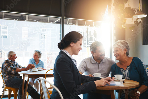 Senior couple, financial advisor and talking with documents in consultation, conversation and retirement plan. Insurance, savings and investment with professional, pension people and cafe discussion