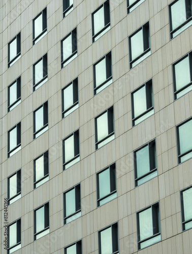 Densely arranged windows on the facade of a modern building.