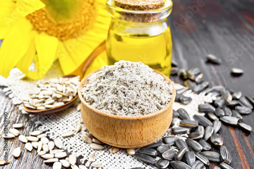 Flour sunflower in bowl with seeds on board