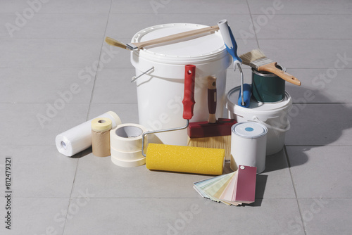 Fototapeta Naklejka Na Ścianę i Meble -  Painting tools and paint buckets on the floor