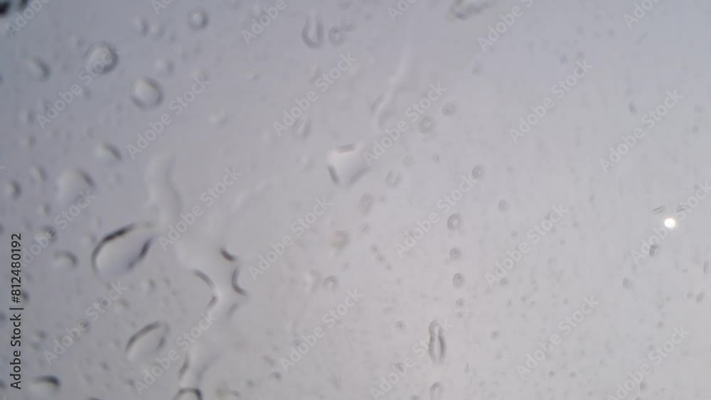 Rain Drops Falling down on background mirror car view, High quality photo of Rain on Window Sky Drops, Close up Slow Rain, Rainy day, Heavy Rainfall. Raining in car traffic. Rain Drops Falling down on background mirror car view, High quality photo of Rain on Window Sky Drops, Close up Slow Rain, Rainy day, Heavy Rainfall. Raining in car traffic.