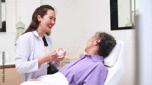 Woman dentist in dental office talking with patient and preparing for treatment. A dentist talking to patient in dentist surgery, a dental check-up.