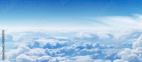 A breathtaking sight of clouds fills the frame as seen from the window of an airplane creating a captivating copy space image