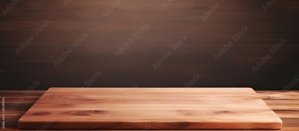 A wooden cutting board on a brown table is captured in a panoramic shot with plenty of copy space for potential images A wooden cutting board on a brown table is captured in a panoramic shot with plenty of copy space for potential images