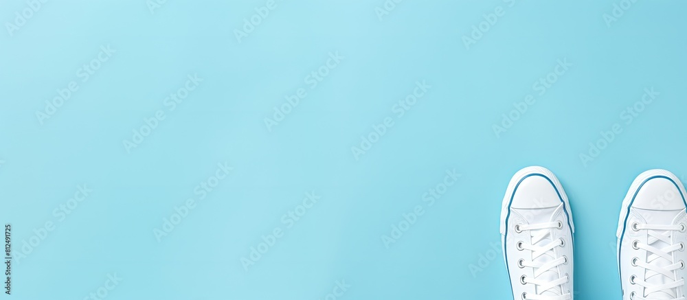 Trendy feminine background with pale white female shoes on a blue backdrop Top view with a flat lay perfect for beauty blog fashion concept Copy space image Trendy feminine background with pale white female shoes on a blue backdrop Top view with a flat lay perfect for beauty blog fashion concept Copy space image