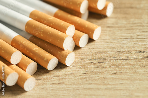 image of several commercially made cigarettes. pile cigarette on wooden. or Non smoking campaign concept, tobacco photo