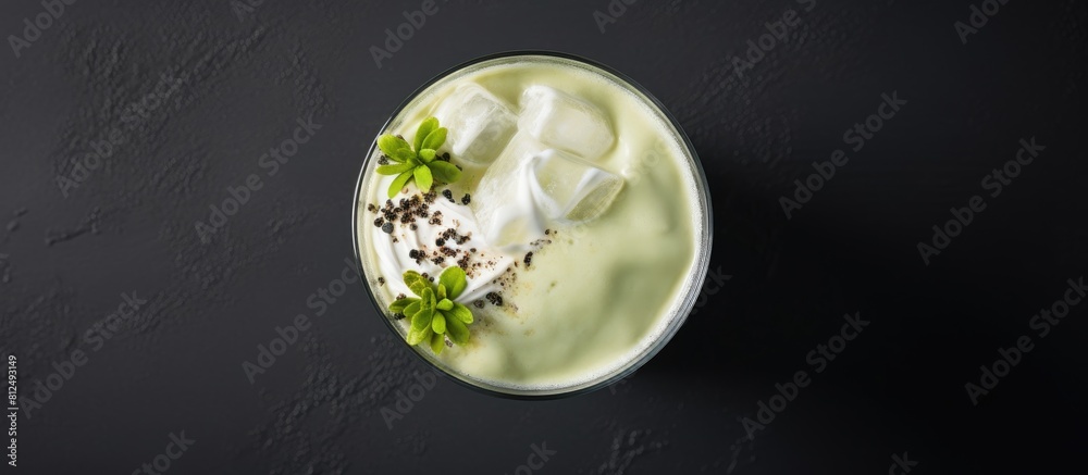 From above you can see a trendy Asian cheese tea topped with creamy foam matcha powder and black tea on a gray background The image provides a copy space for additional content From above you can see a trendy Asian cheese tea topped with creamy foam matcha powder and black tea on a gray background The image provides a copy space for additional content