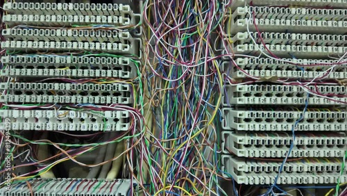 Inside a PABX telephone booth that has a number of connecting cables in many colors in the analog system. communication technology