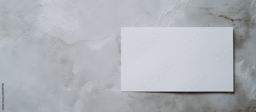 A copy space image of a plain paper with greeting cards nearby viewed from above on a concrete surface A copy space image of a plain paper with greeting cards nearby viewed from above on a concrete surface