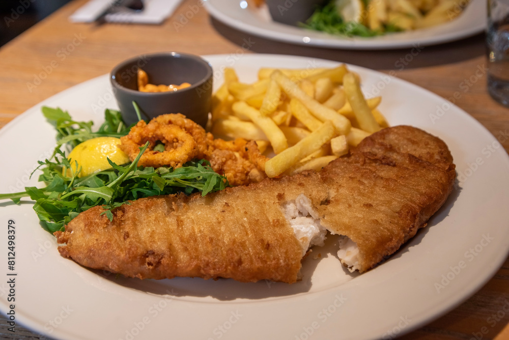 Fried fish and chips and a side salad are a common breakfast meal at the restaurant. Fried fish and chips and a side salad are a common breakfast meal at the restaurant.