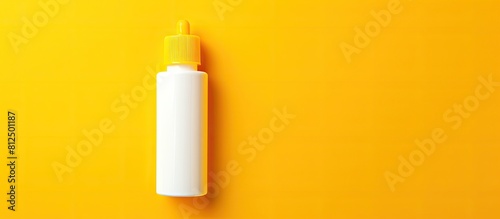 A stationery item specifically a PVA glue bottle is showcased on a vibrant yellow background providing ample copy space for additional elements in an image photo