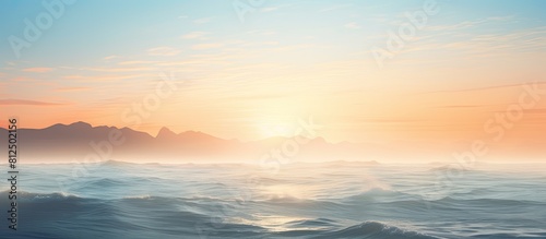 A misty sunrise over the ocean with fog obscuring the view. Creative banner. Copyspace image