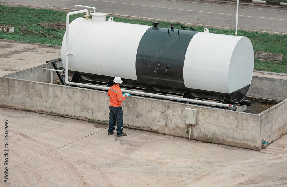 Top view male workers are for check record inspection of storage tank Top view male workers are for check record inspection of storage tank