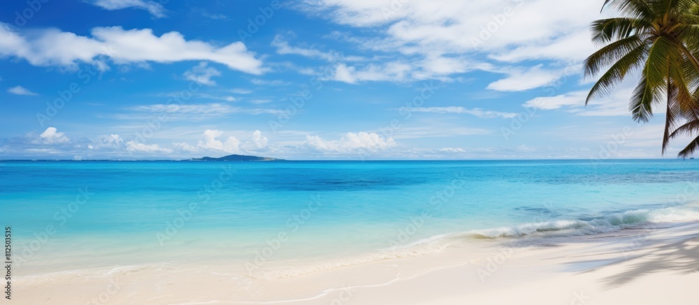 Obraz premium A picture of a perfect tropical beach with white sandy shores crystal clear turquoise waters and a vibrant blue sky as a copy space image
