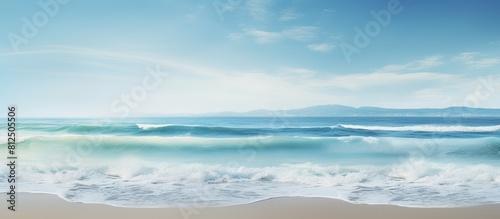 A scenic ocean seascape with waves crashing on a sandy shore providing plenty of copy space in the image