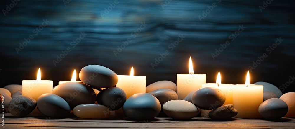 A serene arrangement of candles and spa stones on a wooden backdrop creates a captivating copy space image A serene arrangement of candles and spa stones on a wooden backdrop creates a captivating copy space image
