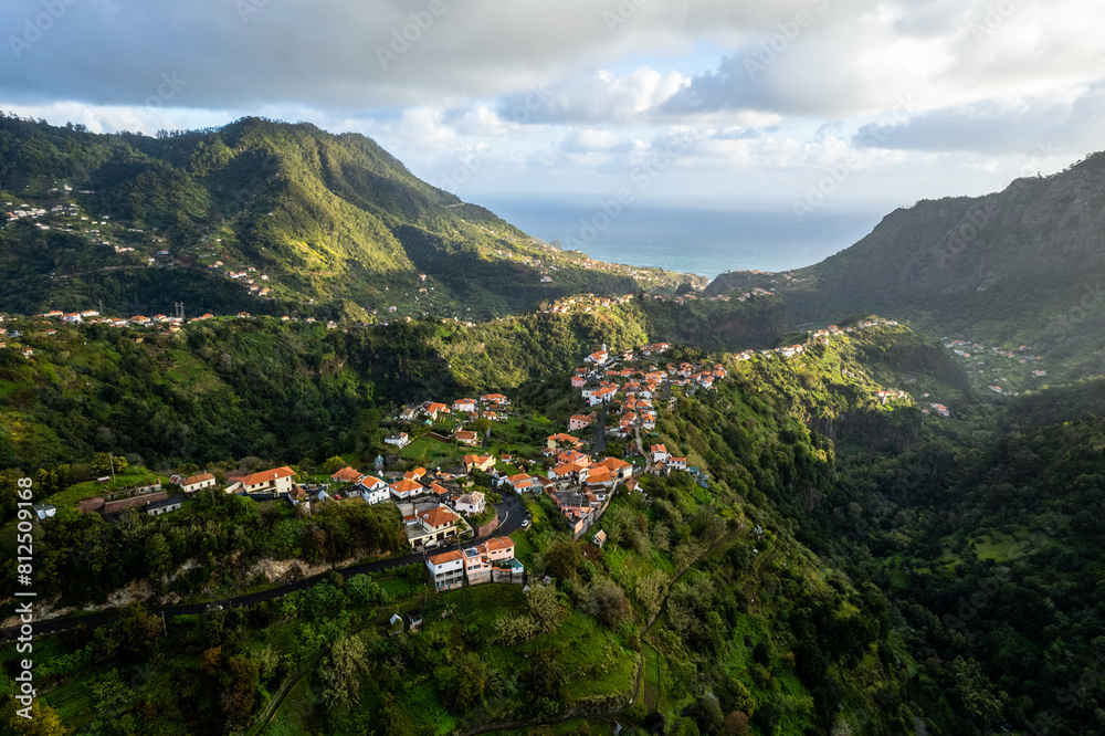 Madeira Island landscape, small village on hills and green lush forest. Aerial drone view. Portugal travel. Madeira Island landscape, small village on hills and green lush forest. Aerial drone view. Portugal travel.