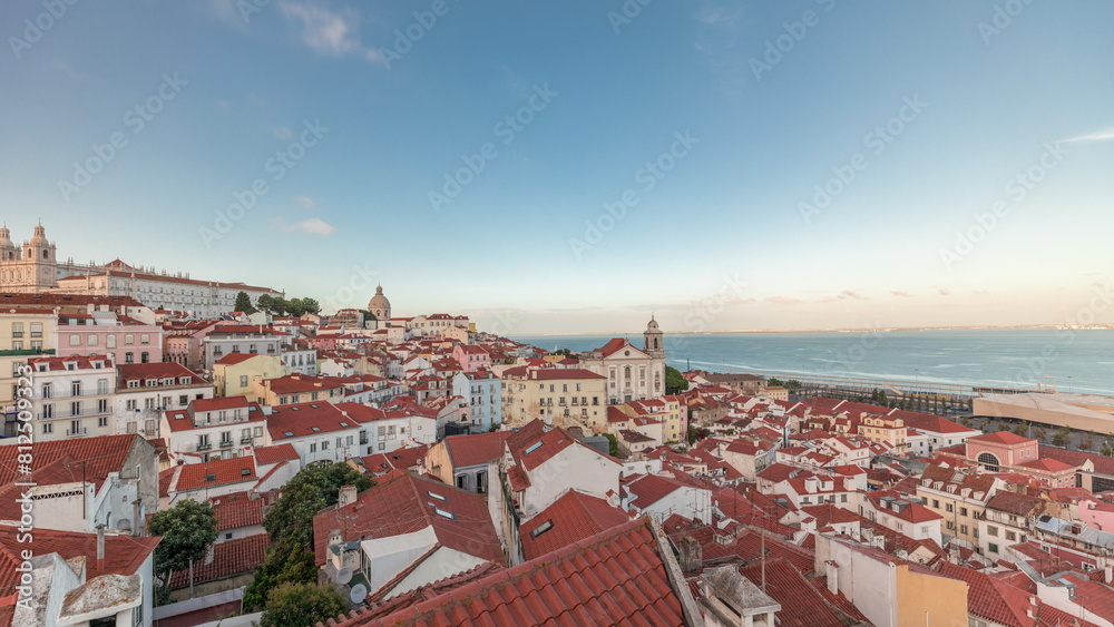 Fototapeta premium Panorama showing aerial view of Alfama in Lisbon timelapse during sunset.