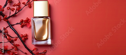 Top view of a golden branch and nail polish on a colorful background providing ample space for text alongside the image photo