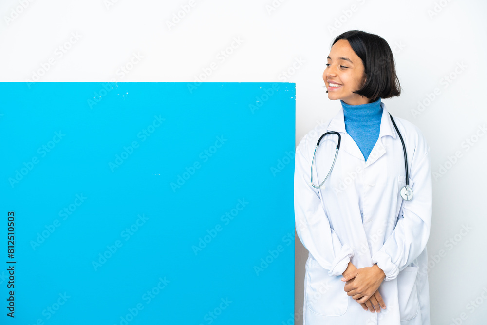 Young mixed race doctor woman with a big placard isolated on white background . Portrait Young mixed race doctor woman with a big placard isolated on white background . Portrait