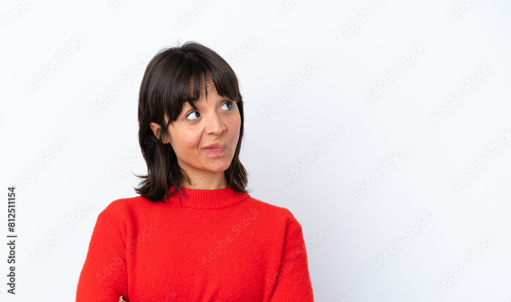 Young woman isolated on white background making doubts gesture while lifting the shoulders