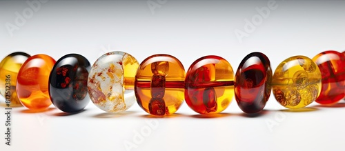 A vibrant collection of red and yellow amber beads stands out against a clean white backdrop These beads made from the ancient resin of natural minerals are crafted into jewelry that women can wear a