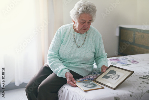 Quadro em tela Memory, frame and elderly woman on bed with picture for melancholy, family history and nostalgia